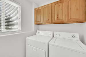 Laundry room featuring washer and dryer and cabinet space