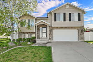 View of front of house featuring brick siding, driveway, and an attached garage