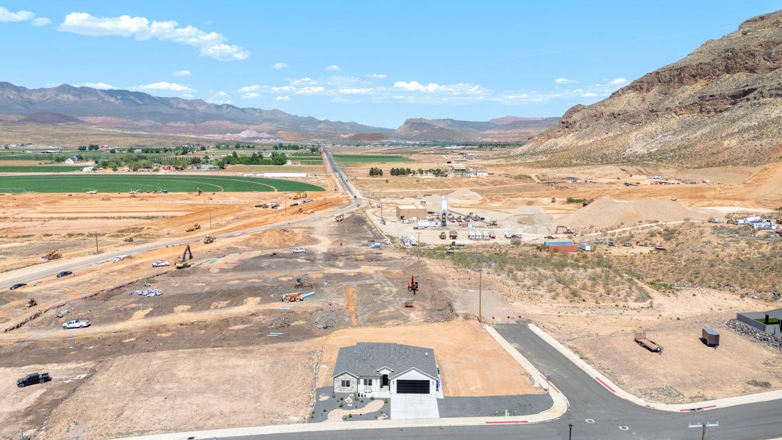 Aerial view of property's location featuring a mountainous background