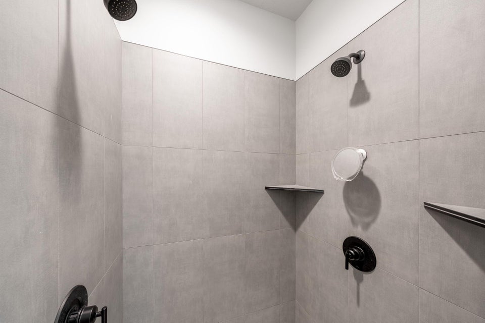 Bathroom view of a tile shower