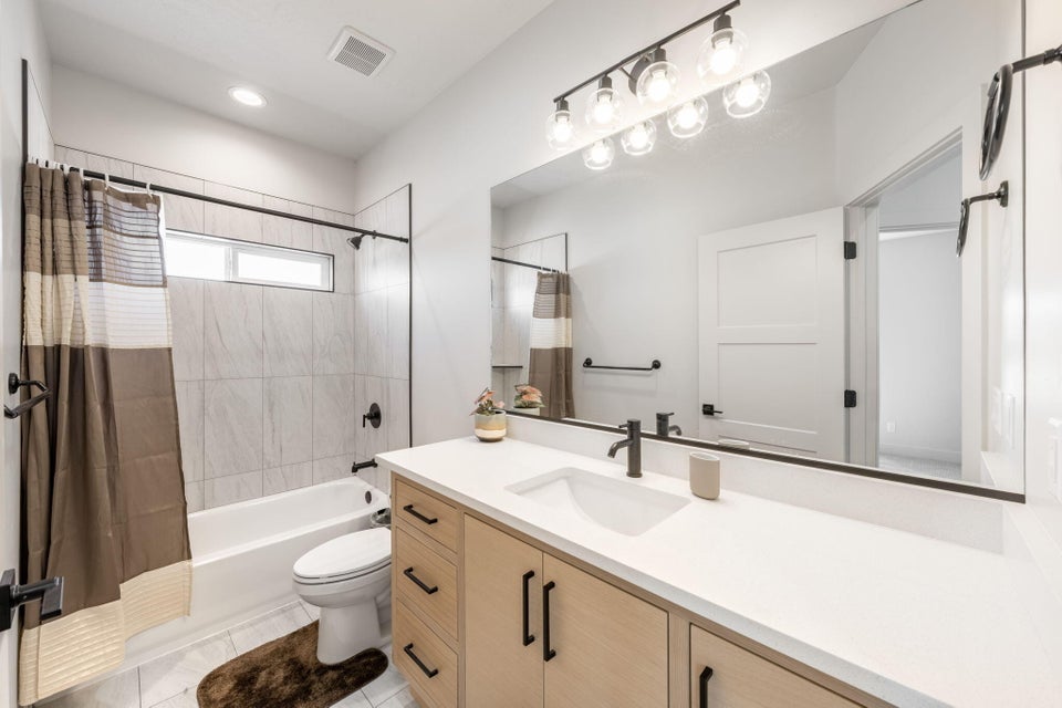 Full bath featuring vanity and shower / bath combo