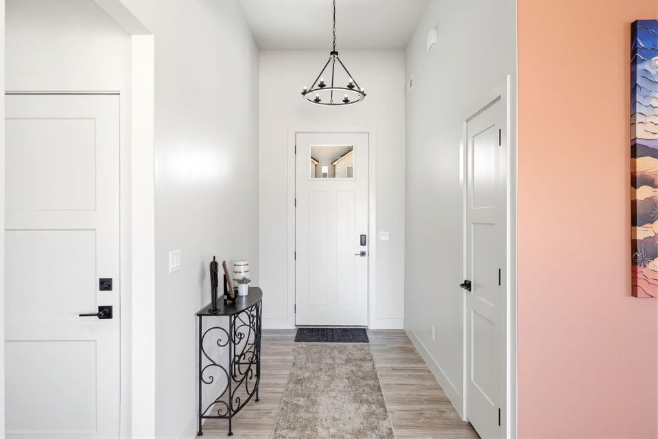 Foyer with light wood-style floors and baseboards