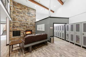 Bedroom featuring a fireplace and light wood-style flooring