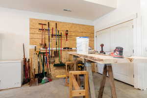 Miscellaneous room with unfinished concrete flooring