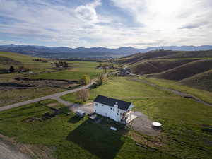 View of rural area with a pastoral area and a mountain backdrop