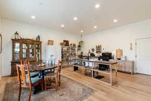 Dining room featuring light wood-style flooring and recessed lighting