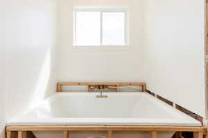 Full bathroom featuring a bath