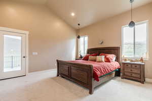 Bedroom featuring light carpet, recessed lighting, vaulted ceiling, and access to outside