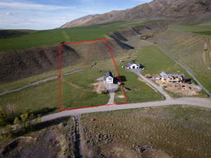 View of rural area with property boundaries highlighted, large plots for crops, and mountains