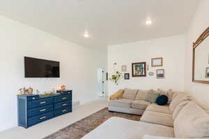 Living area with carpet and recessed lighting