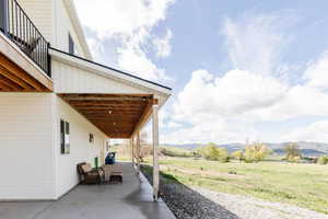 View of patio / terrace with a mountain view and a rural view