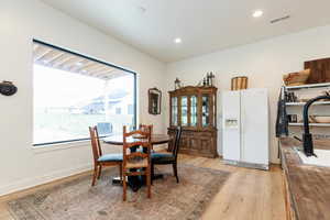 Dining space featuring light wood-style flooring and recessed lighting