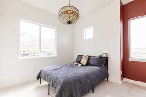 Carpeted bedroom featuring baseboards and a mountain view