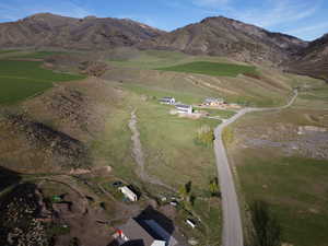 Aerial view of property and surrounding area featuring rural landscape and mountains