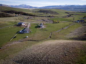Aerial view of property's location with rural landscape and mountains