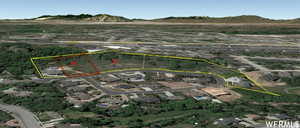 Aerial overview of property's location with property boundaries highlighted and a mountain backdrop