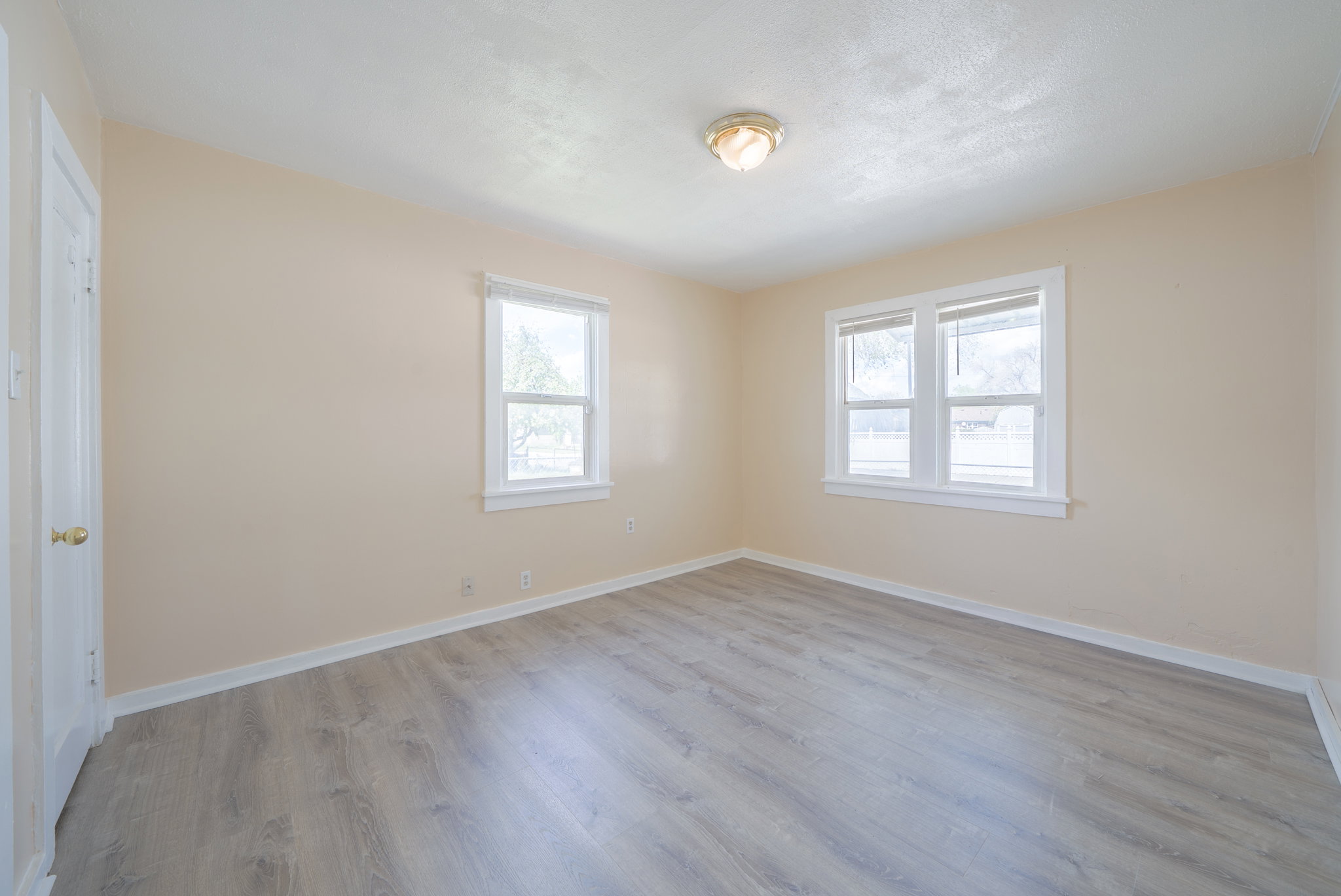 Unfurnished bedroom featuring baseboards and light wood-style floors