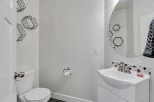 Half bath with vanity and toilet