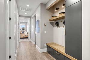 Mudroom with light wood-style flooring and recessed lighting