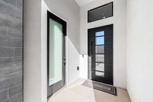 Doorway to property with stucco siding