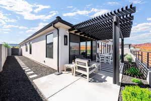 Fenced backyard with a pergola, a patio, and a mountain view