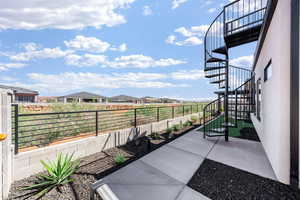 Fenced backyard with stairway and a residential view