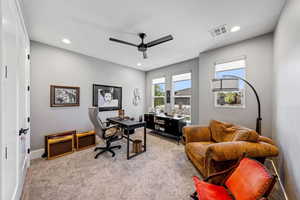 Office area featuring light carpet, a ceiling fan, and recessed lighting