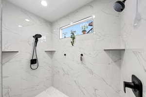 Bathroom with a marble finish shower