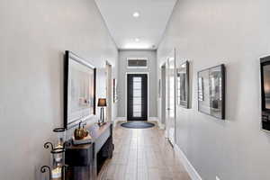 Foyer featuring baseboards and light wood-style floors