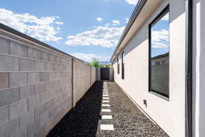View of property exterior featuring a fenced backyard and stucco siding