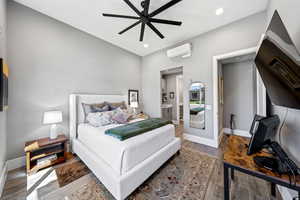 Bedroom featuring wood finished floors, connected bathroom, a ceiling fan, and recessed lighting