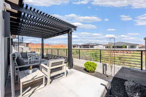 View of patio featuring a pergola, outdoor dining space, and a residential view