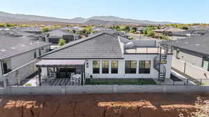 Rear view of property with a patio area, a fenced backyard, a residential view, and stucco siding
