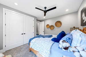 Carpeted bedroom featuring a closet, ceiling fan, and recessed lighting