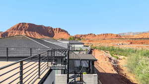 View of property exterior with a mountain view and a balcony