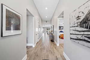 Hall featuring light wood-style flooring and baseboards