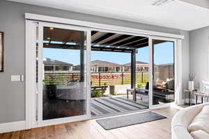 Doorway featuring a residential view and wood finished floors