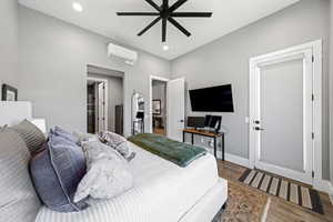 Bedroom with wood finished floors, a ceiling fan, and recessed lighting