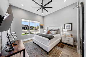 Bedroom with light wood finished floors, recessed lighting, and ceiling fan
