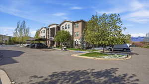 View of property featuring a mountain view and covered parking