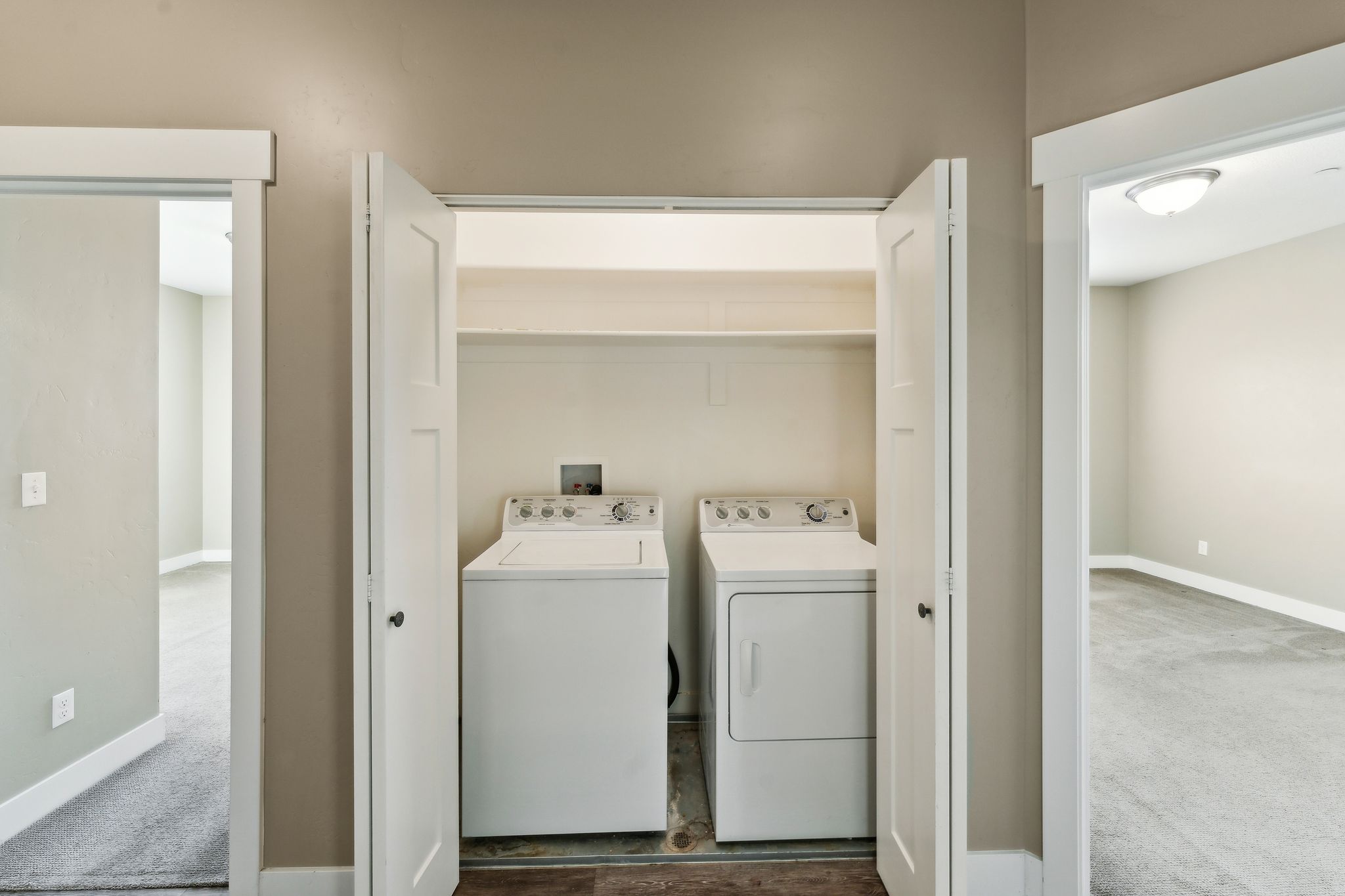 Laundry area featuring washer and clothes dryer and carpet floors