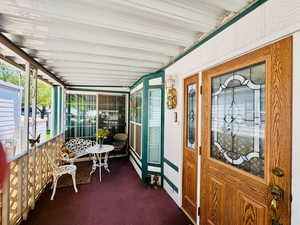 Sunroom / solarium featuring a porch