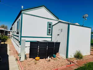 View of side of property featuring a storage shed