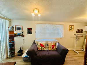 Sitting room featuring a textured ceiling and light wood-type flooring