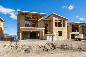 Property in mid-construction with an exterior structure, a patio, and an outdoor structure