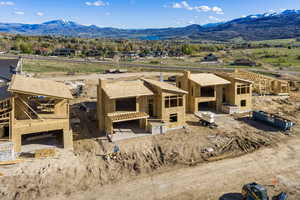 View of front of house featuring a mountain view, a patio area, and a residential view