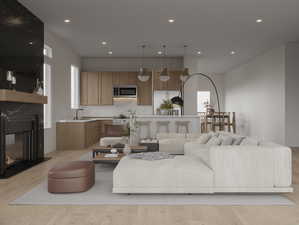 Living area featuring a premium fireplace, light wood-style floors, recessed lighting, and healthy amount of natural light
