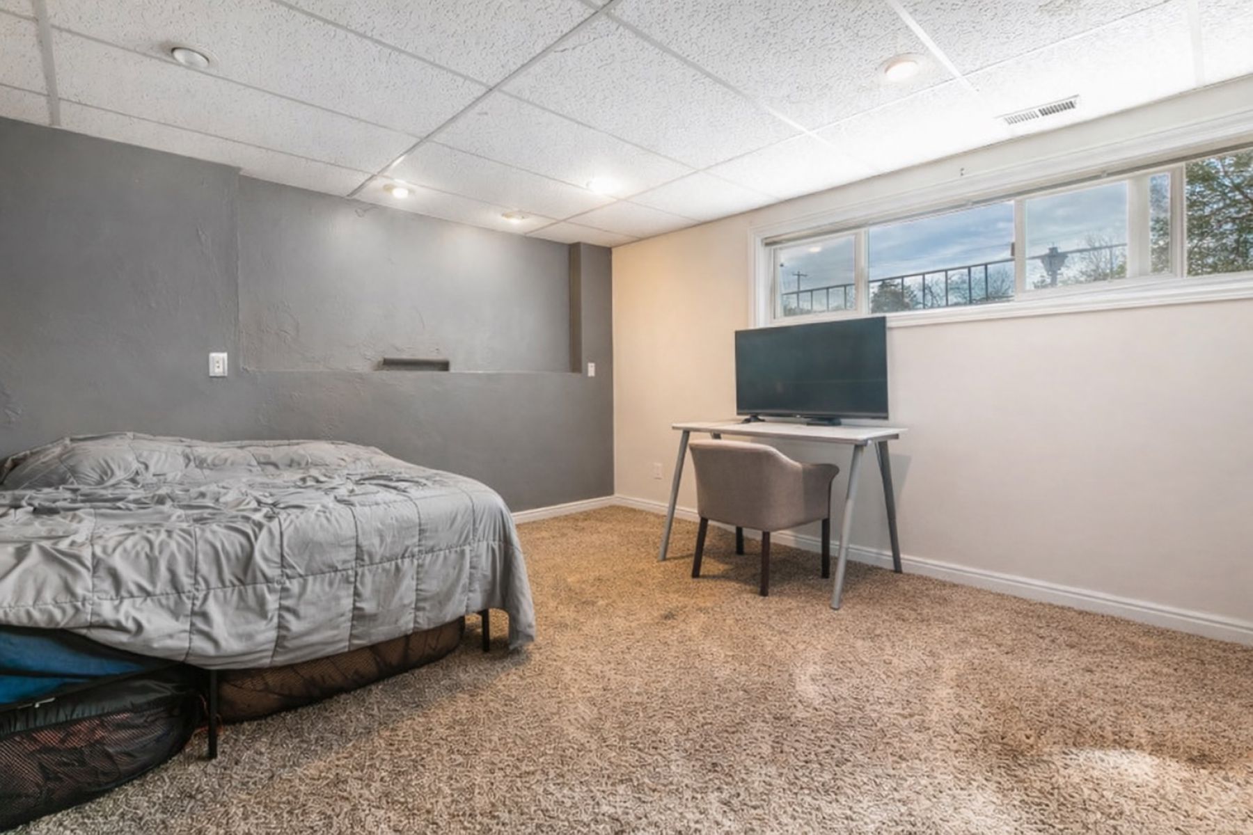 Bedroom featuring a paneled ceiling and light carpet
