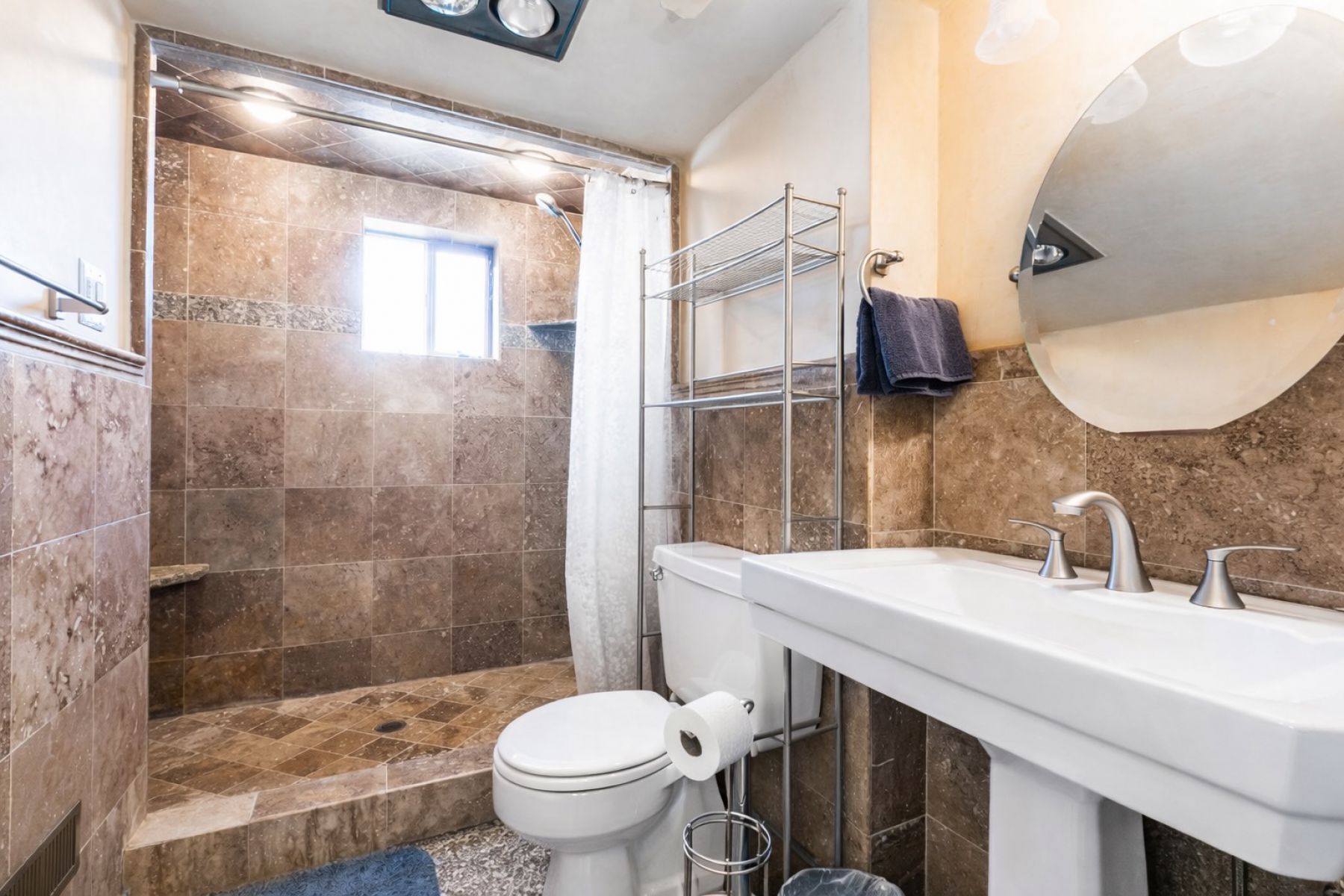 Full bath featuring tile walls and a shower stall