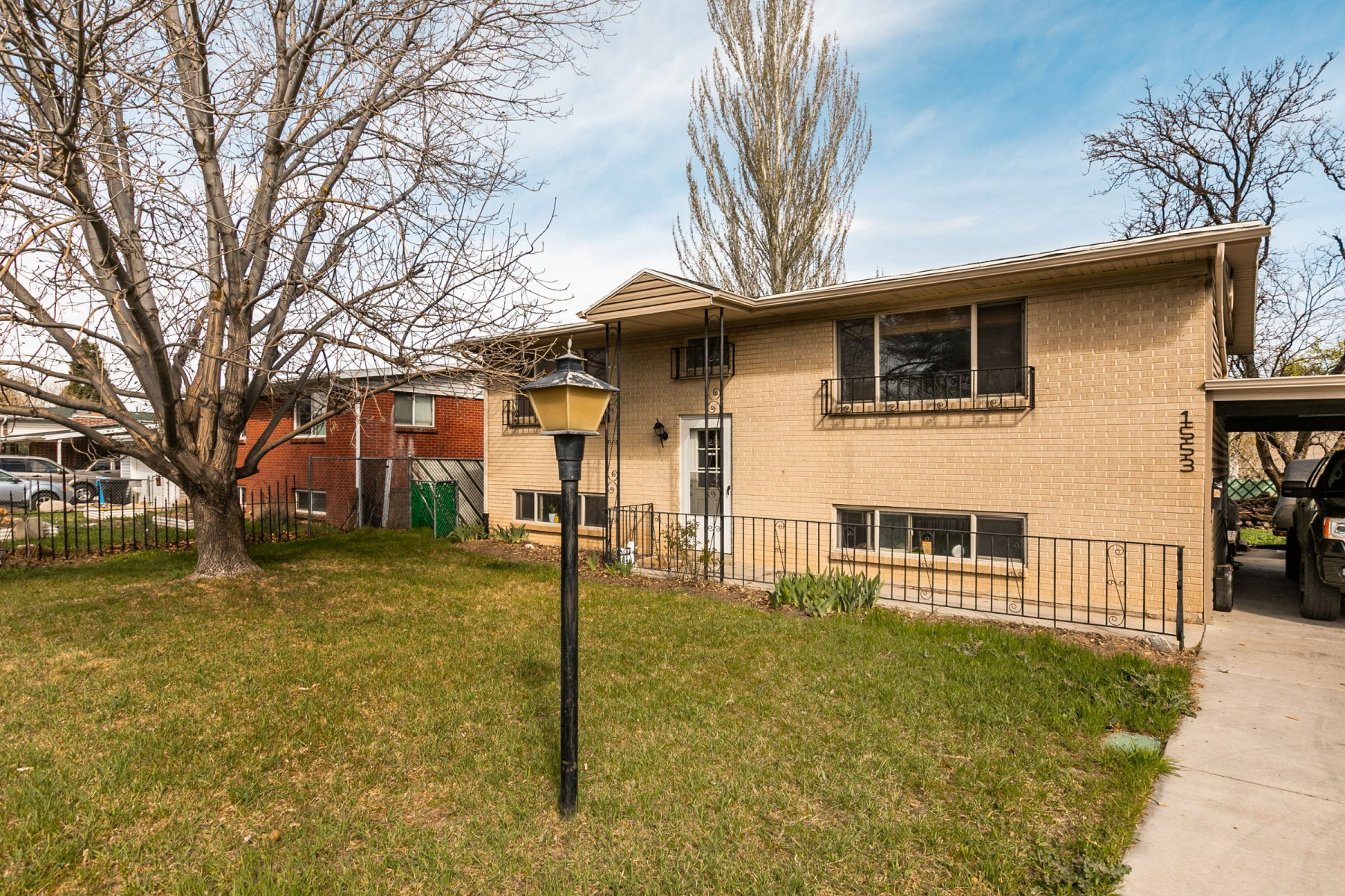 Rear view of property featuring a carport and brick siding